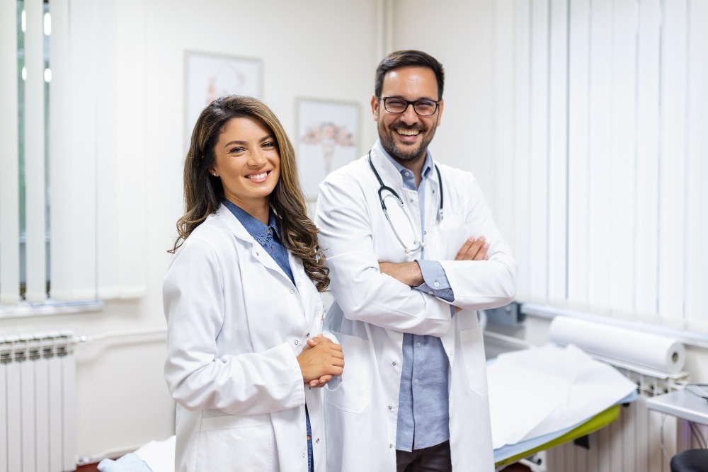 Two smiling doctors in a clinic, representing thousands of trusted providers on Doctastic